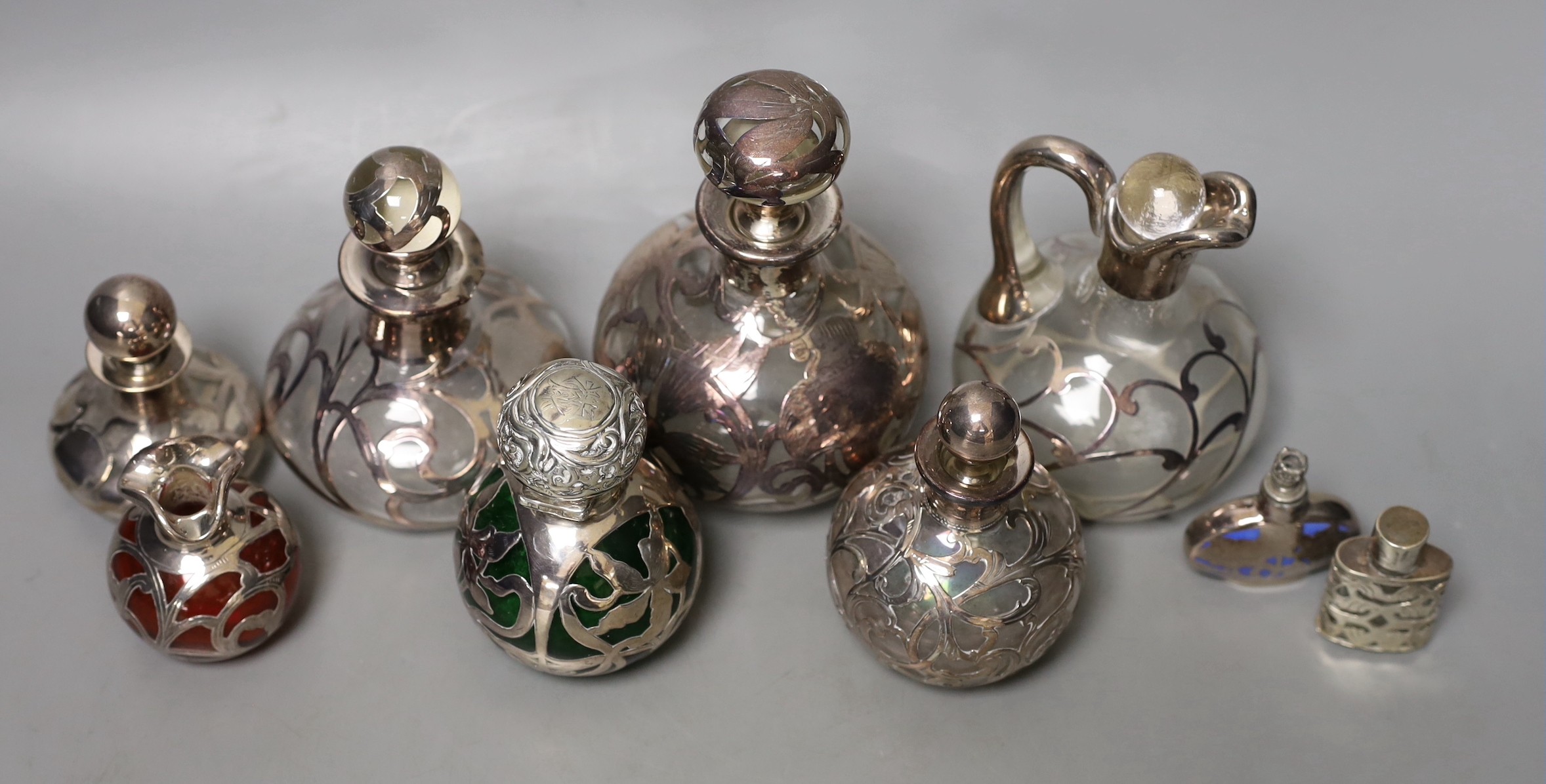 A group of white metal jacketed scent bottles, jugs etc (group)